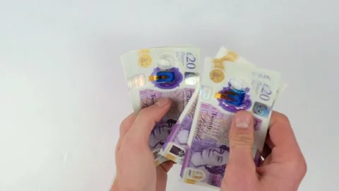 Paying the debt with British Pounds Stock Footage 165848342