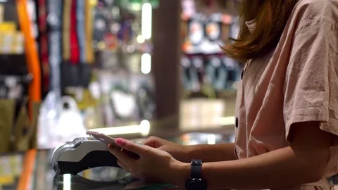 Paying with smartphone device wirelessly over credit card transaction Stock Footage 115064955