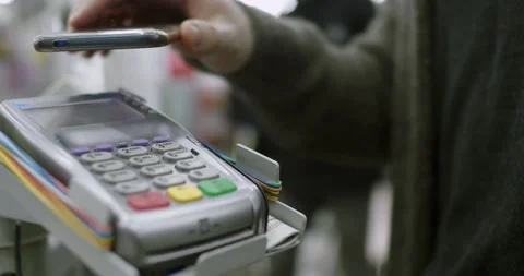 Paying through smart phone using NFC technology. Close-up. 4K modern technology Stock Footage 336585629