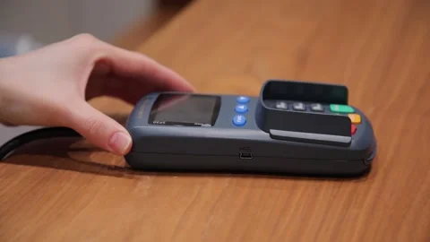 Payment by card through the terminal. Close-up. The seller pushes the terminal. Stock Footage 136627082