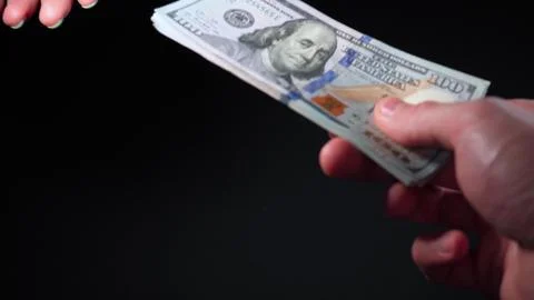 Payment in cash with one hundred dollar USA banknotes. The girl pays in cash Stock Photos