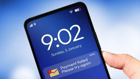 Payment failed and try again notification appearing on the smartphone screen Stock Footage 310883466