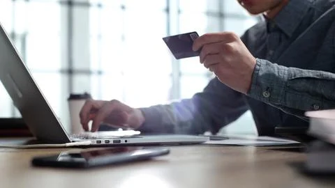 Payment for goods on a computer via a payment card 스톡 사진
