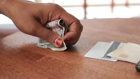 Payment method choices on wooden table in bright setting Stock Footage 303196109