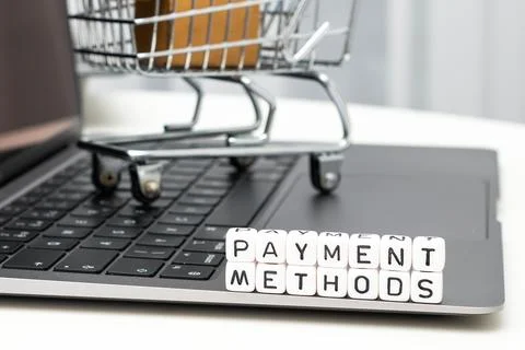 Payment methods words on cubes with a toy shopping cart and cardboard boxes in Stock Photos