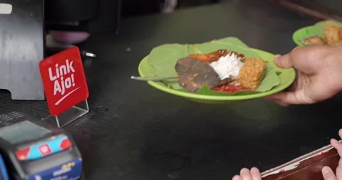 Payment for Nasi Jamblang typical of Cirebon, West Java, Indonesia in Stock Footage 224123711