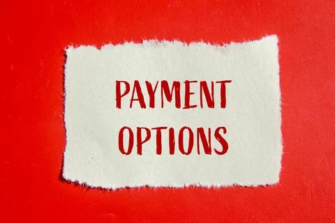 Payment options message written on ripped torn paper piece with red backgroun Fotos Stock