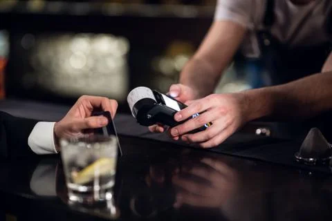 Payment for an order in a bar using a non-cash payment method Stock Photos