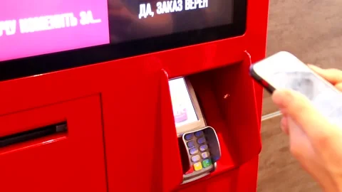 Payment by phone for the order in KFC. Modern technologies. . KFC restaurant Stock Footage 154888985
