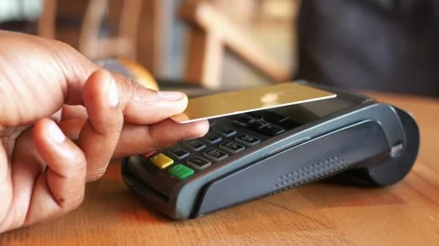 Payment process at a cafe with a pastry on the table Stock Footage 305532443