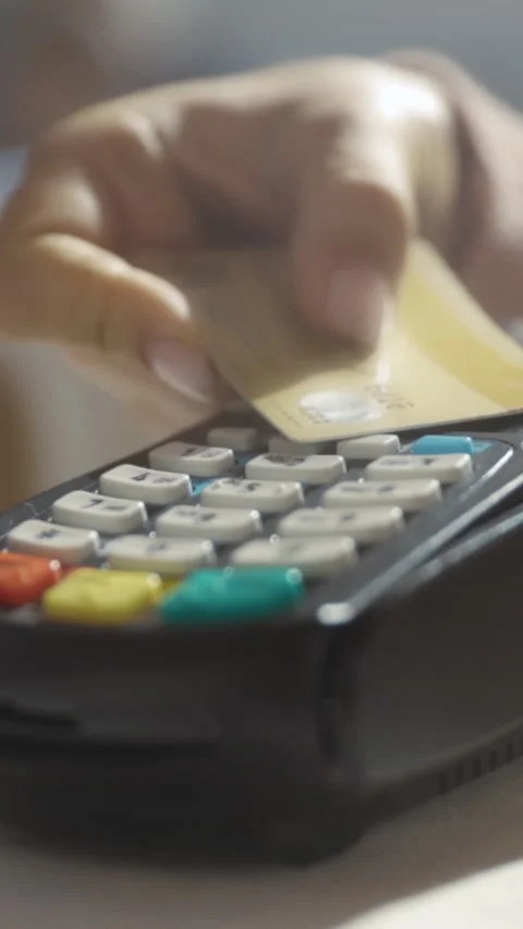 Payment process at checkout, Customer taps gold card at point of sale with Stock Footage 329935193