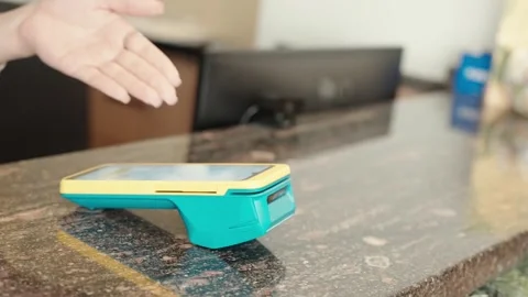 Payment process at the reception desk using a card reader device Stock Footage 327389583