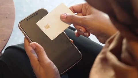 Payment process with a smartphone and a card in a modern setting Video stock 307921658