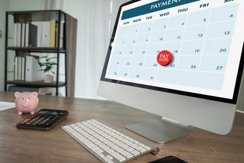 Payment reminder calendar on computer screen Bill due date highlighted on d.. Foto stock