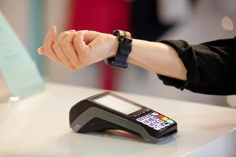 Payment for services using a watch through the terminal Stock Photos