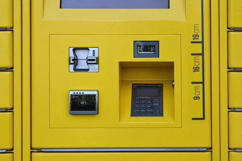 Payment terminal interface on a yellow parcel locker station Photos