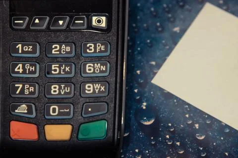 Payment terminal on the table with a sheet of paper Foto stock