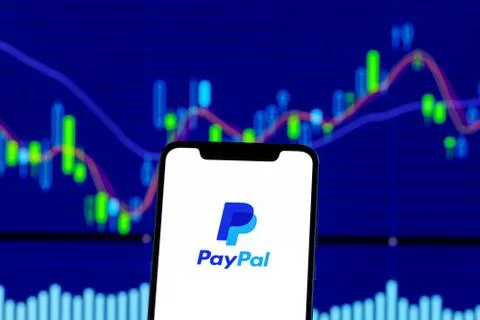 Paypal logo is seen on an android mobile phone over stock chart 스톡 사진