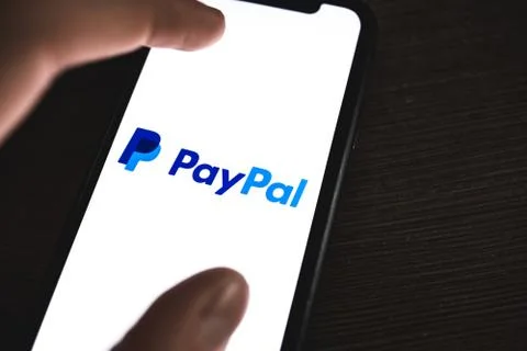 PayPal logo on the smartphone screen. Stock Photos