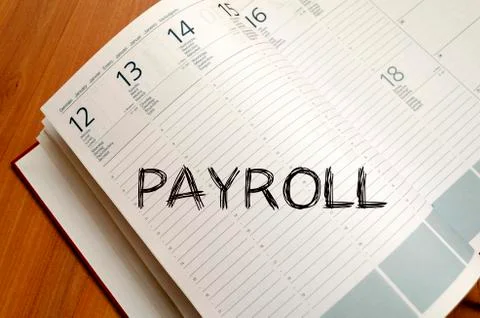 Payroll write on notebook Stock Photos