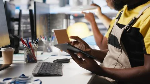 PC based solar technician reviews automation data in production factory Stock Photos