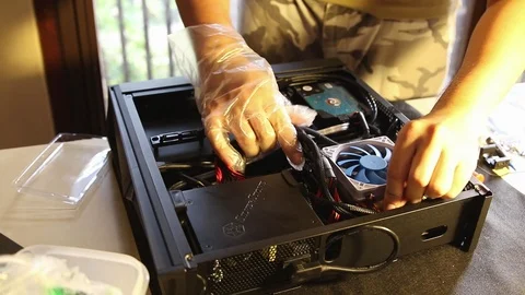 PC builders (Technician) doing a cable management to tidy up the interior of pc Stock Footage 102192345
