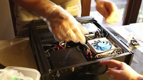 PC builders (Technician) doing a cable management to tidy up the interior of pc Video stock 102192384