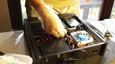PC builders (Technician) doing a cable management to tidy up the interior of pc Stock Footage 102192469