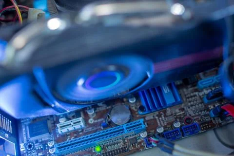 PC components in dust. The cooling fan of the video card is working. Inside the Stock Photos