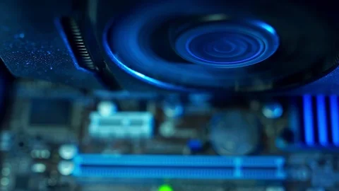 PC components in dust. Extra close-up, the working fan of the video card inside 動画素材 101874345