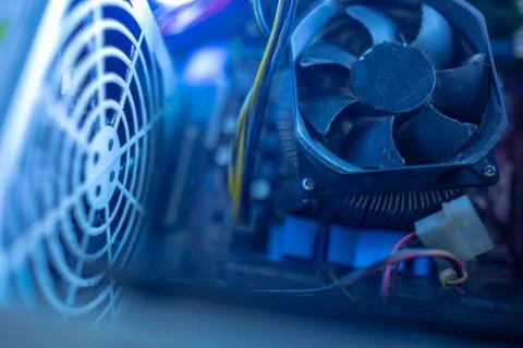 PC components in dust. macro CPU fan. It does not work, power unit fan grille Stock Photos
