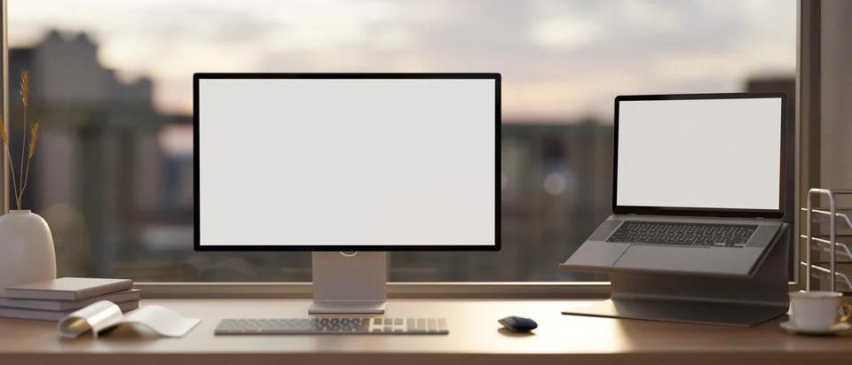 A PC computer and laptop mockup and office supplies on a table against the .. 스톡 일러스트
