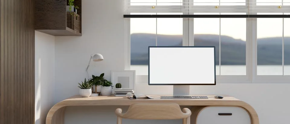 PC computer white screen mockup on a modern wooden desk against the window .. Stock Illustration