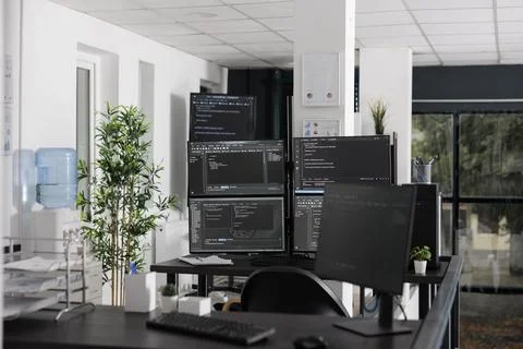 Pc desk with multiple monitors running terminal window Stock Photos