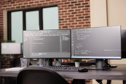 Pc desk with pc monitors running terminal window Stock Photos