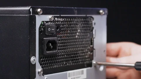 PC disassembly. Close-up of a service worker unscrews the screws securing the Stock Footage 105569202