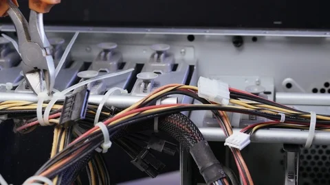 PC disassembly. The service worker removes plastic ties from the wires inside Stock Footage 105569204