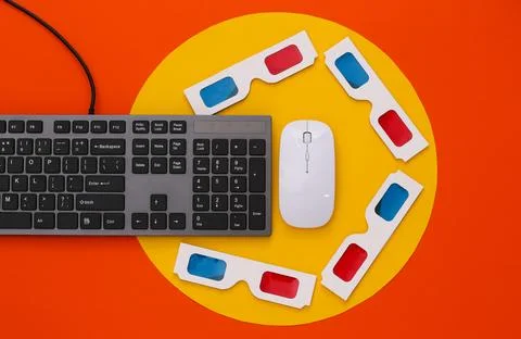 PC keyboard with 3d glasses on orange background with yellow circle. Entertai Stock Photos
