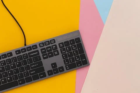 PC keyboard on colored background. Top view Stockfoto's