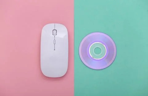 Pc mouse with cd on pink blue pastel background. Top view Stockfoto's