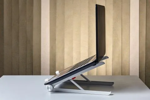 PC notebook is opened and mounted on cooling rack. Stock Photos