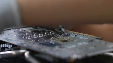 PC technician screws chipset of graphics card to ventilator installing it. Stock Footage 113480277