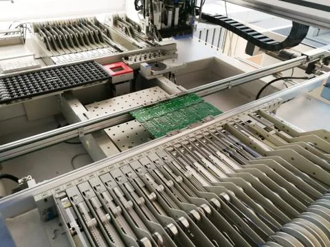 PCB assembly first stages. PCB on the rails of production line inside pick an Foto stock