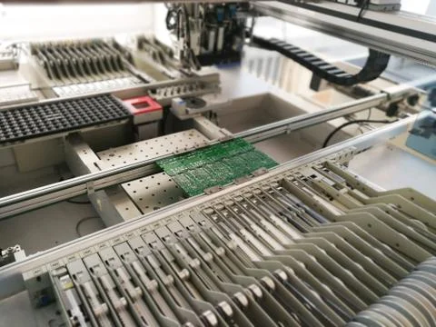PCB assembly first stages. PCB on the rails of production line inside pick an Stock Photos
