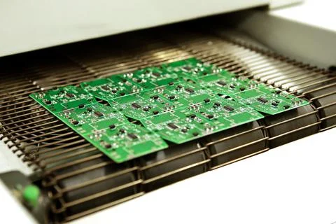 PCB drying technology. The finished board leaves the drying oven along the co Stock Photos