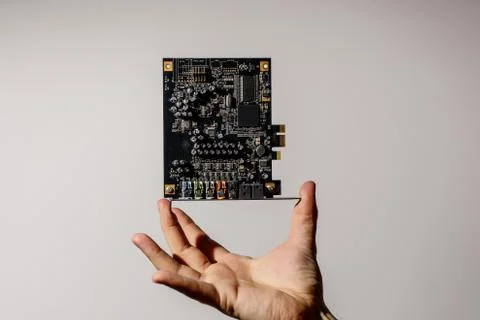 PCI Express card for computer in hand, audio chip Stock Photos