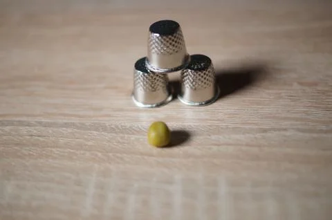 Pea and three thimble Stock Photos