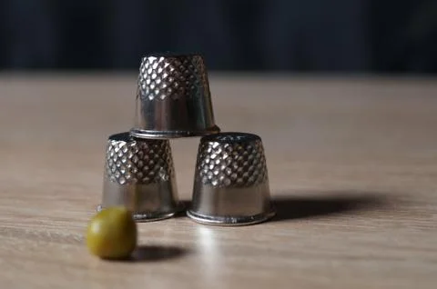 Pea and three thimble Stock Photos