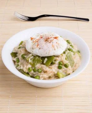 Pea risotto with egg fresh vegetarian pea risotto with poached egg Copyrig... Stock Photos