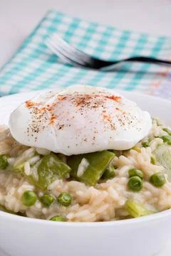 Pea risotto with egg fresh vegetarian pea risotto with poached egg Copyrig... Stock Photos